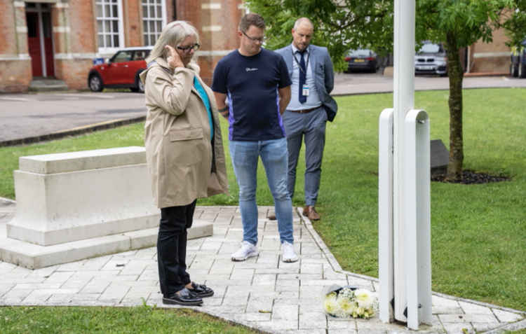 Current Senior Investigating Officer DCI Stuart Truss lays flowers at Essex Police's Chelmsford Headquarters with Danielle's mum Linda and brother Mitchell.