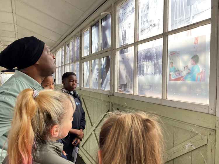 Artist Everton Wright (EVEWRIGHT) talking to children from the Gateway Learning Community Schools about his work 'The Windrush Walkway of Memories' at the London Cruise Terminal