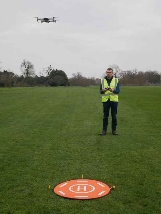 Matthew Bristow operates a drone to gain aerial photographs of the site.