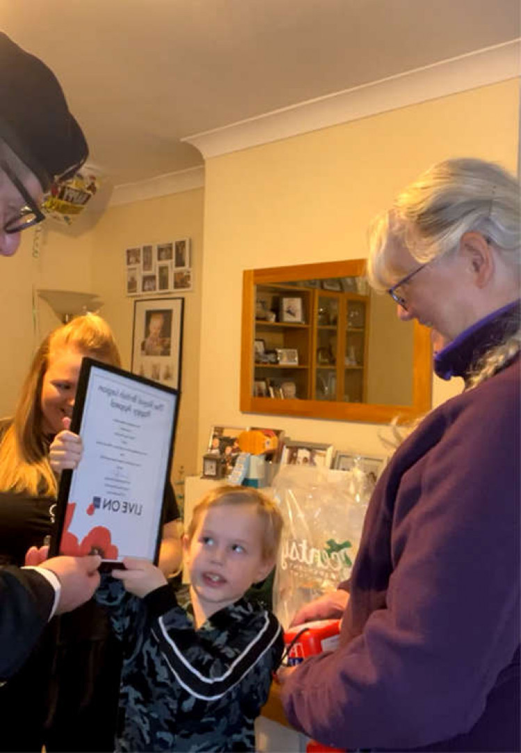 Rod Oakley presents Logan with his certificate.