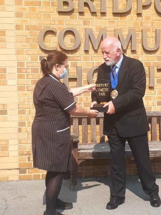 Bridport mayor, Cllr Ian Bark presents the Charter Fair Trophy to Bridport Community Hospital matron Ellen Homes