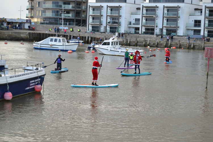 The Santa paddle boarders in West Bay harbour