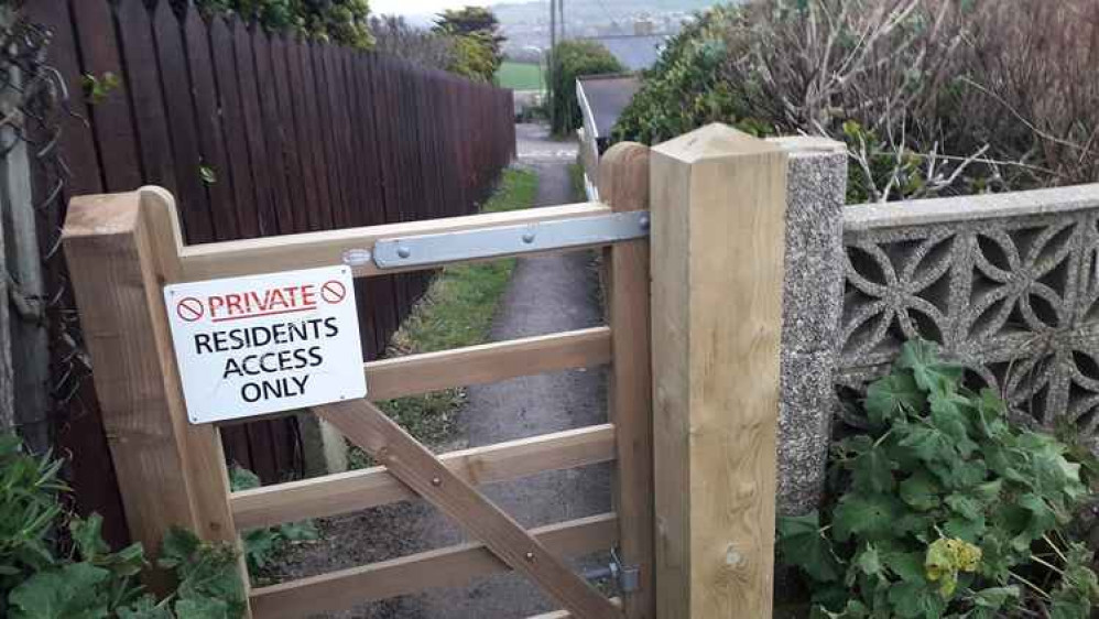 The gate and signage on one of the routes leading into West Cliff