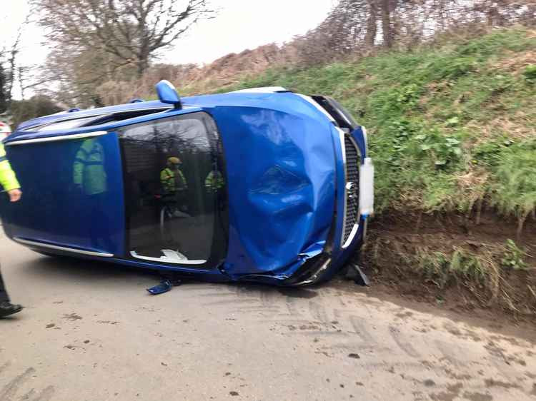 The car crashed and flipped onto its side on Pymore Road Picture: Bridport Fire Station