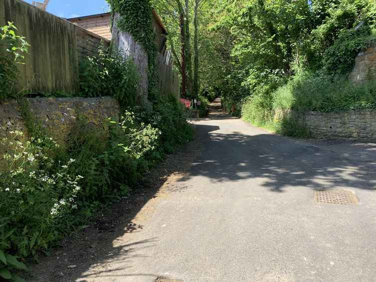 The road turns into the lane, going up towards Colmer's Hill