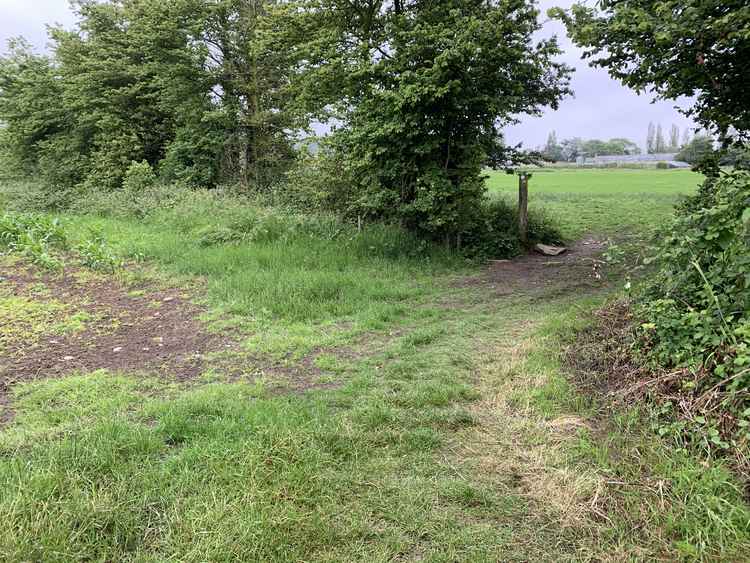 Follow the path round to the right before going diagonal through the field towards a barn