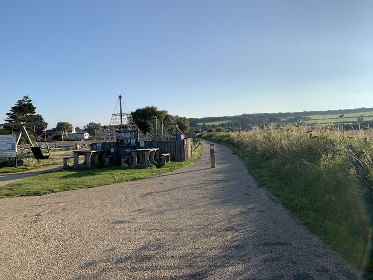 Take the path next to the play area