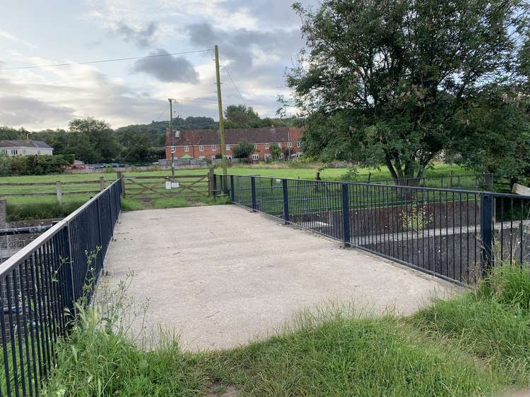 Cross the bridge and go over the metal stile