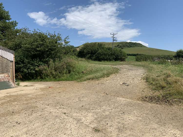 Go past the barn and follow the path round to the left