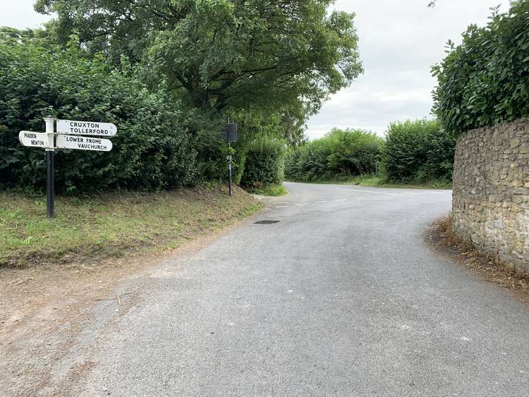 As the road turns sharply right and continue straight, passing Downfrome House and a little chapel on your left