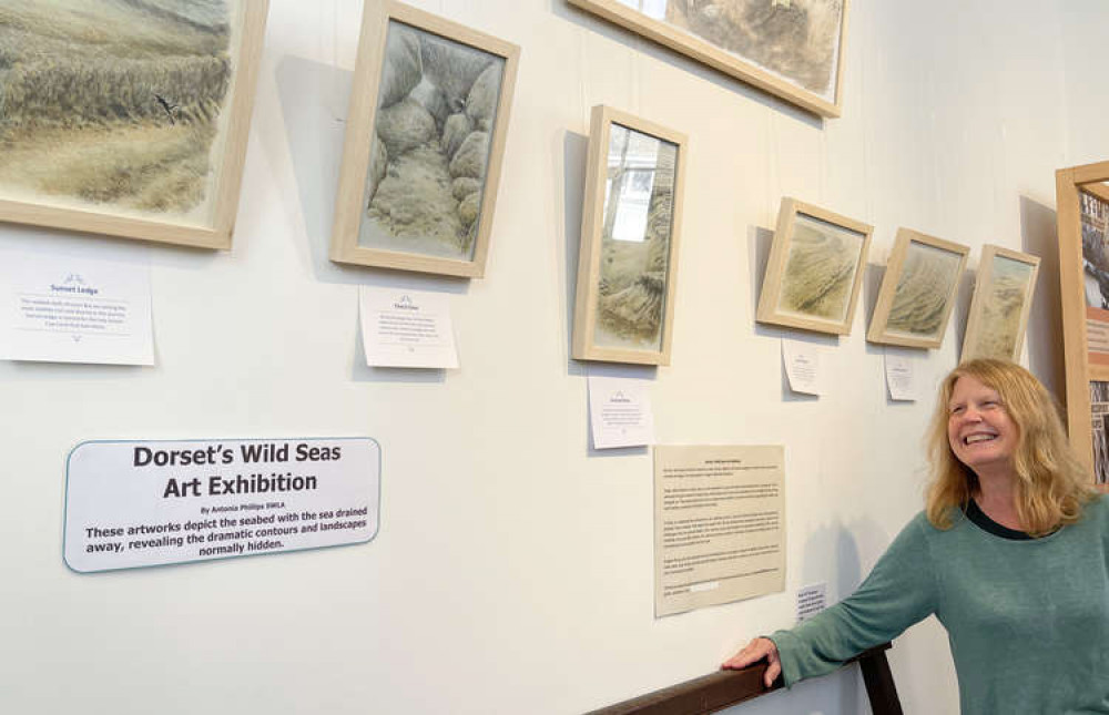 Artist Antonia Phillips with her artwork at West Bay Discovery Centre