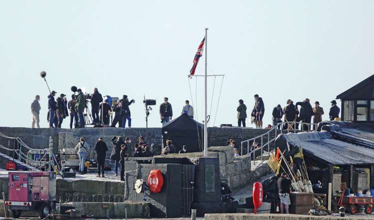 Film crews on the historic Cobb harbour, with actor Matt Lucas pictured on the high wall second from right Image: Paul Starck