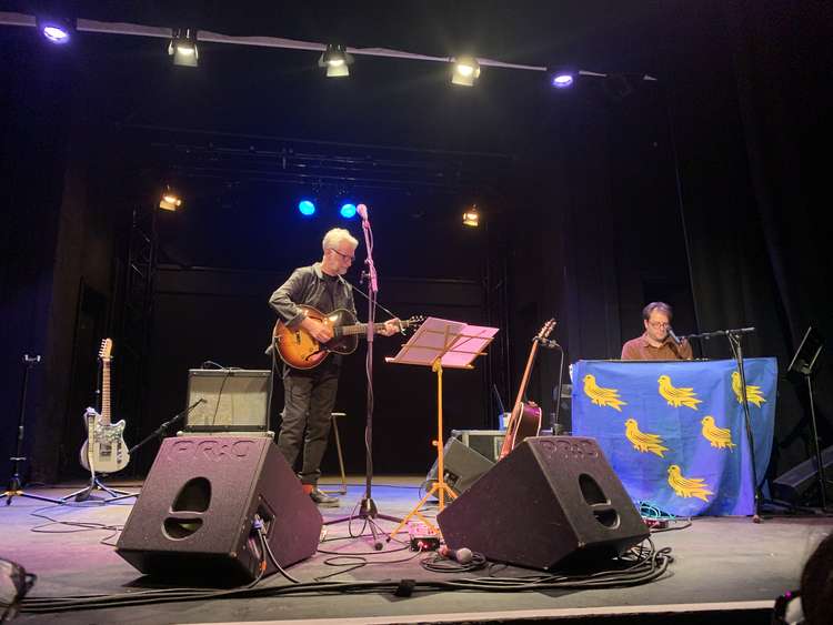 Billy Bragg on stage at Bridport Arts Centre with keyboard player Thomas Collison