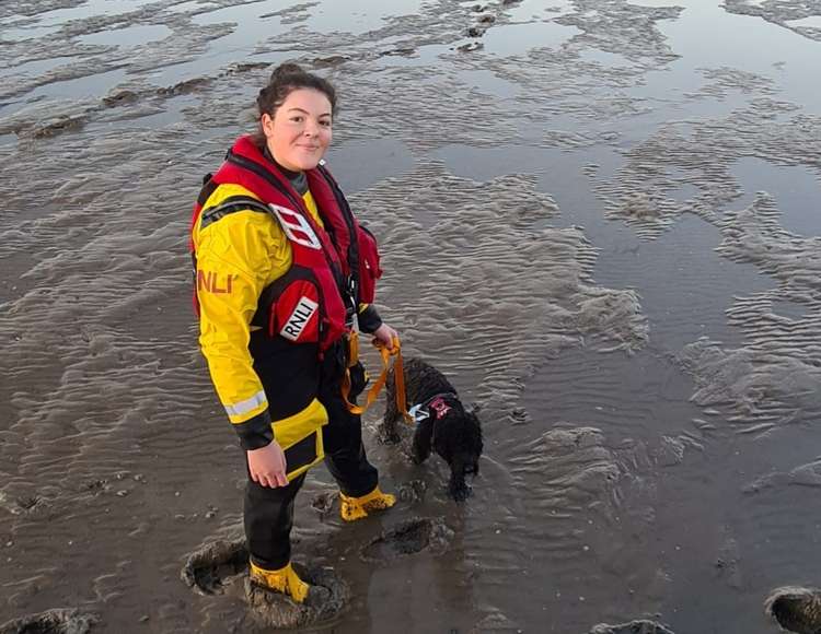 Rescued dog securely attached to Ella Marston - Credit: RNLI/Chris Gatenby