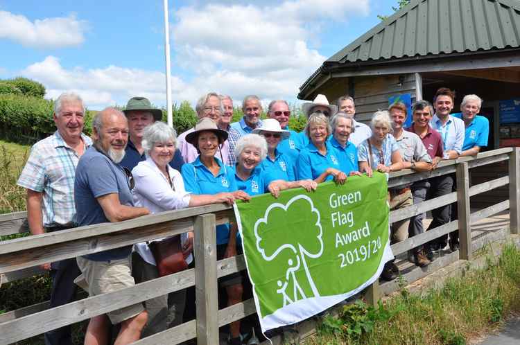 Seaton Wetland volunteers, members of East Devon's Countryside team, ward members and East Devon's environment portfolio holder Cllr Jung celebrate the attraction being awarded a Green Flag