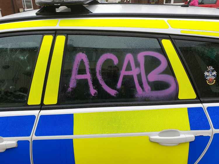 Police vehicles, the police station and seafront buildings were targeted with an anti-police, abusive acronym