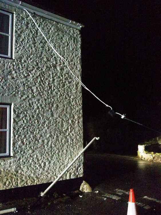 Colyton fire crew were called out as a cable became detached from a house in Whitford, blocking the road