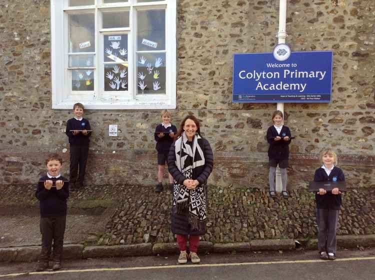 Head of school Mrs Mills and children from Colyton Primary Academy with their new devices