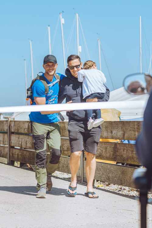 Alex and Mike cross the finishing line together on Seaton seafront