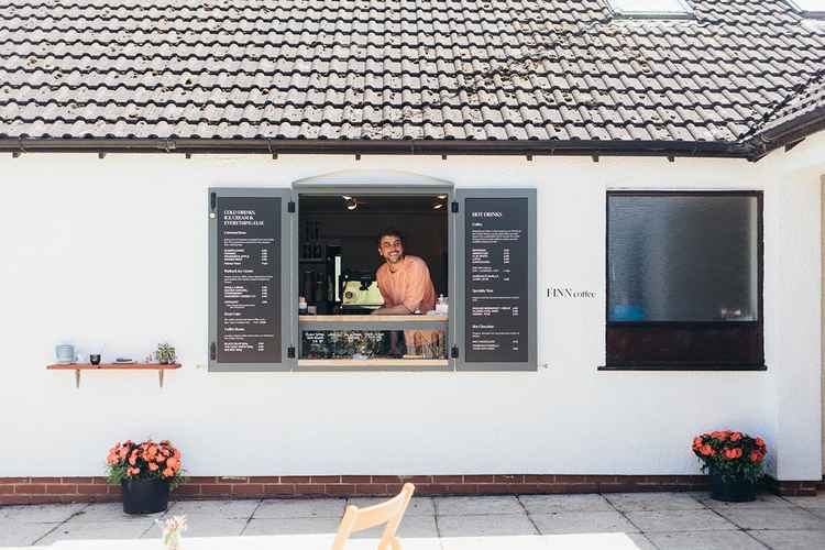 George serving in the coffee kisok adjoining his new studio and gallery