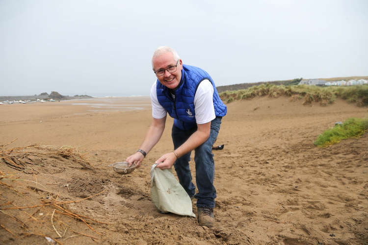 Seaton Lottery winner Neil Smart picking litter on Bude beach