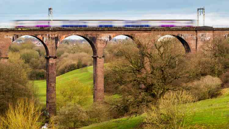 Train speeding over viaduct into Congleton Station, by Mark Sandbach