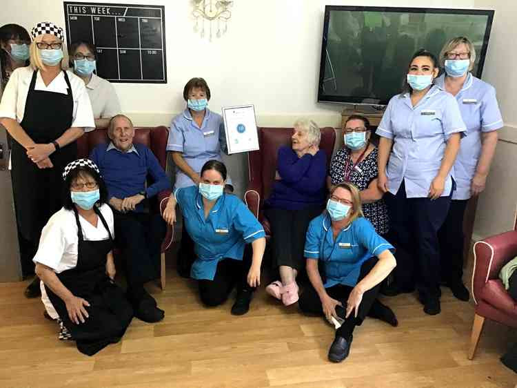 Park Lane staff and residents proudly display their '10' certificate.