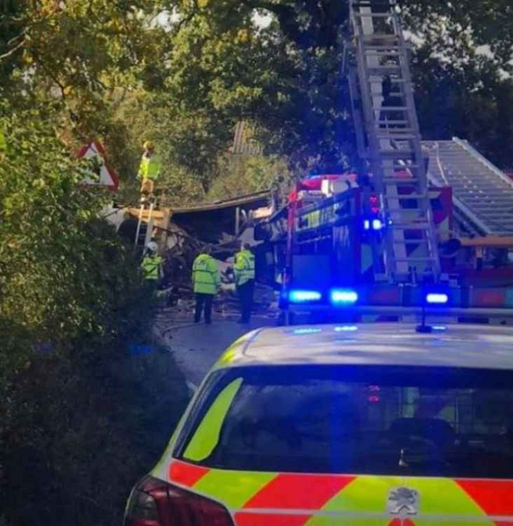 Major road closed as HGV loaded with timber topples over