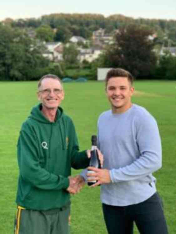 Uplyme & Lyme Regis ended their league fixtures on a high with another defeat over Ottery St Mary, with man of the match Joe Elsworth scoring his maiden century, pictured here being presented with a bottle of champagne by club secretary Derek Wellman