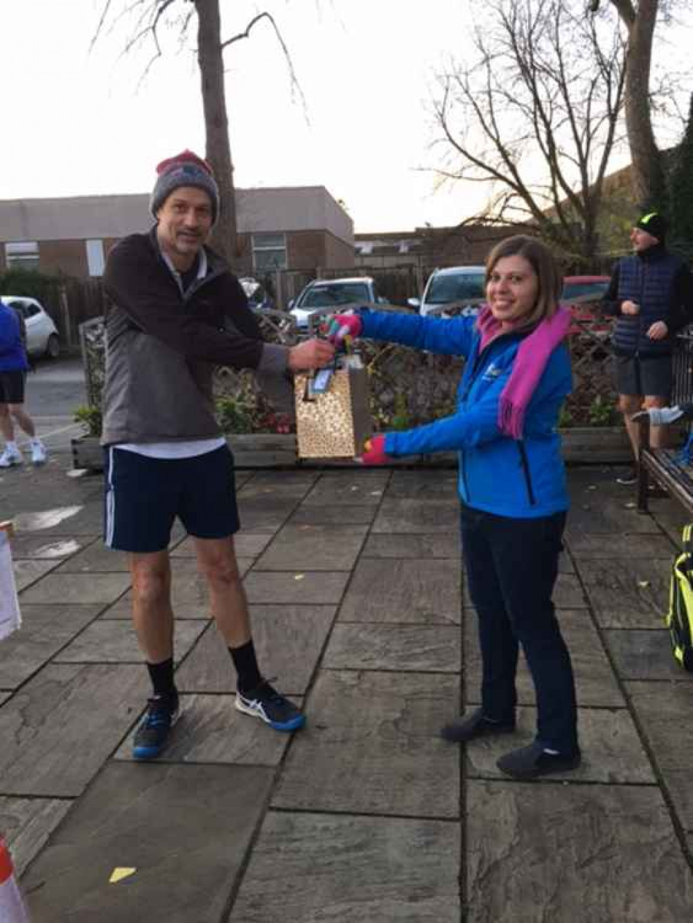 Mark Smith receives his prize for being one of the winners of the Festive Fun Tournament from Becky Spall from sponsors Barking Mad.
