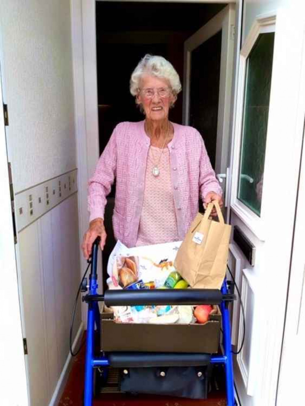 Ada receiving food parcel from Age UK.
