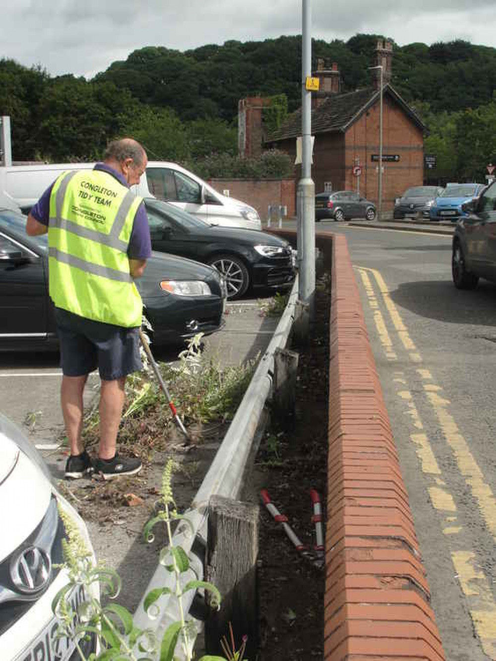Cllr Brown removing weeds at Princess Street Car Park during a Congleton in Bloom Tidy Town Day.
