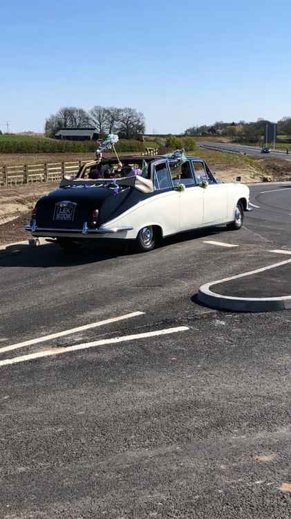 Members of Elizabeth's Group in a classic Daimler car.