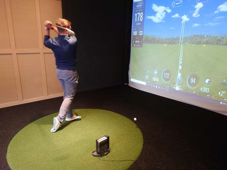 Even if you have never played golf, groups of friends can have fun sessions on SkyTrak. (Image: Ant Goodwin)