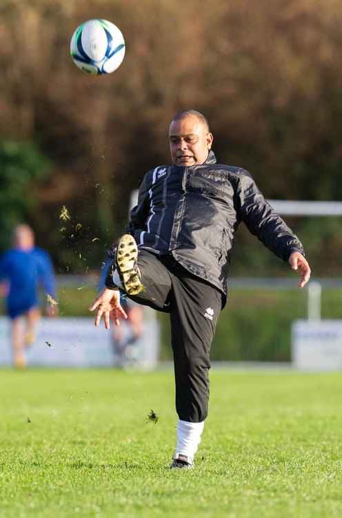 Axminster Town manager Josh Stunnell joins in the pre-match warm-up before the Tigers' match with Crediton United