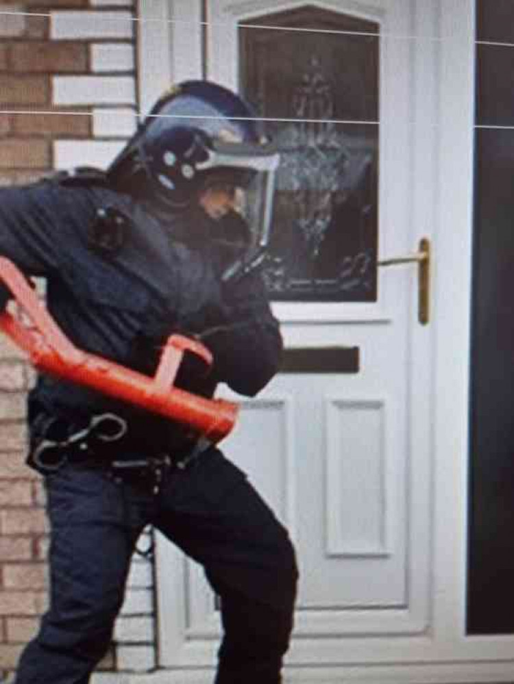 Police conducting one of the raids (Image: Cheshire Constabulary)