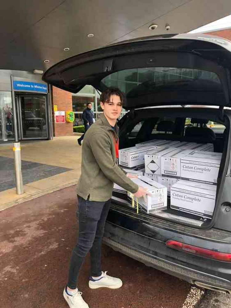 Ollie picking up the hand sanitiser at Whiston Hospital in Merseyside.