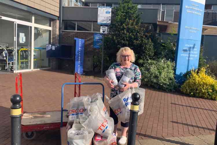 Nurse Geraldine collecting blankets for hospital patientsbought through donations.