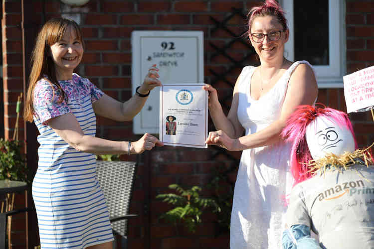 Anne White presenting Lorraine Brown with her winners certificate