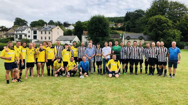 Owen and Les Bounds pictured centre with the teams from Uplyme Football Club and the local emergency services wearing a Lyme Regis kit (photo credit: Uplyme Football Club)