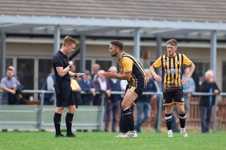 NEVER REF! Jamie Price is booked in Axminster Town's FA Vase 1-0 defeat against Brixham AFC