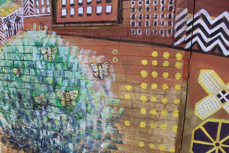 As figures are hard to draw on bricks, especially when viewed for a distance, the silk moths are one of two living creatures represented on Macc's latest mural.