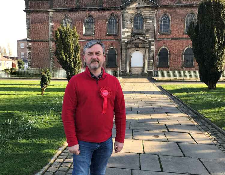 Sandy wants to promote town centre recovery - increasing and using the green space in the Town Centre and protecting its heritage. Here he is pictured outside Christ Church in the Town Centre.