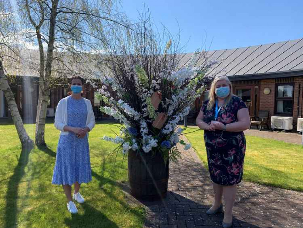 Neptune Knutsford Store Leader Joanna Makant (left) and East Cheshire Hospice Chief Executive Karyn Johnston (right) with the gorgeous six-and-a-half-foot floral display at the Hospice.