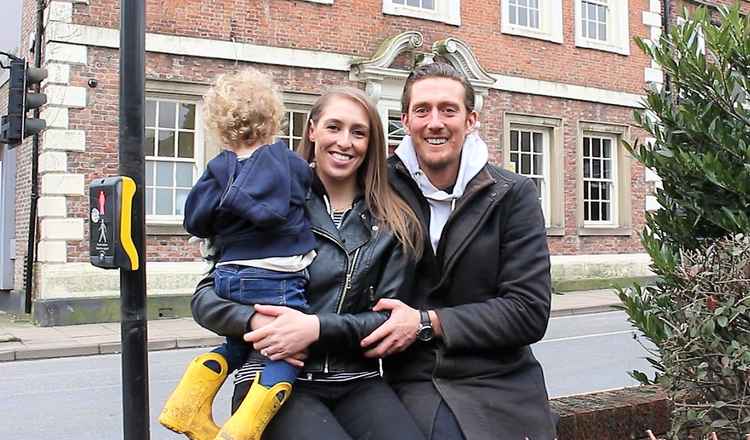 Amy and Rick outside their premises with their two-year-old son Marcus. They are elated with having met their Kickstarter goal, and can't wait to open their two-floor restaurant and bar for the people of Macc.