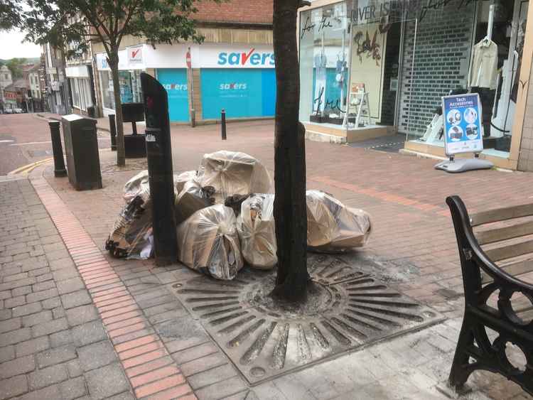 The paving has since been restored, while the tree remains standing but clearly damaged.