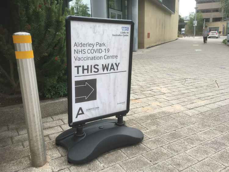 A Macclesfield lady walks in just after 11am this morning to get her first jab, at the Nether Alderley conference turned vaccination centre.