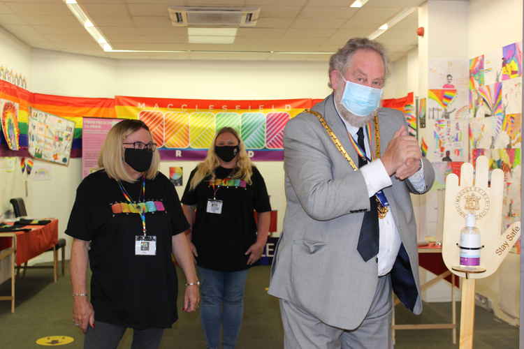 Macclesfield Pride volunteers (left to right) Kay and Paula, are pictured with the masked-up Mayor, who is sanitising following entry to the temporary Macc Pride premises.