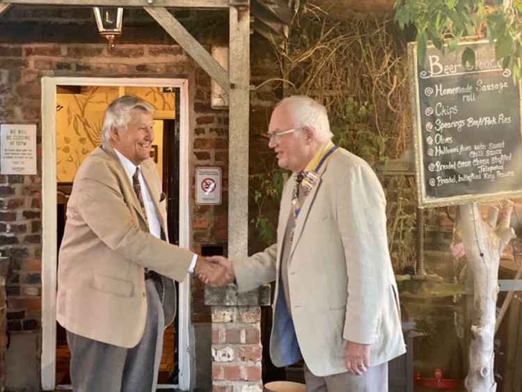 The exchanging of presidents at the Macclesfield Rotary club, with last year's president Chris Watson congratulating new No. 1 Bob Bracegirdle.