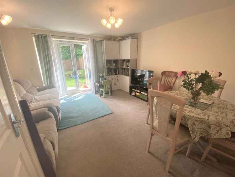 The living room backs out onto the garden with white French doors.